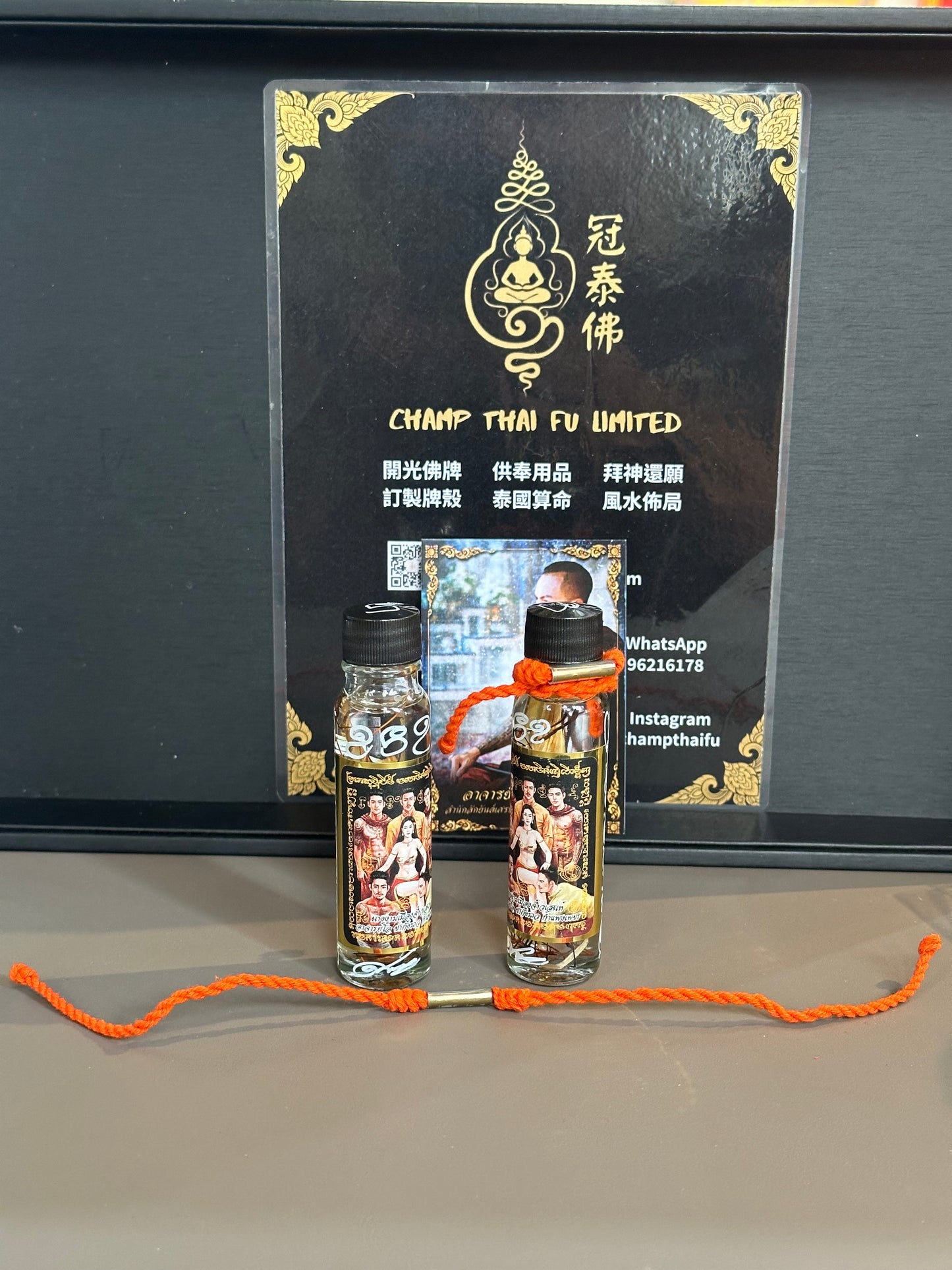 Ajarn Ocha's Queen's Charm Oil comes with a free charm, popularity, and wealth-attracting hand/foot rope.