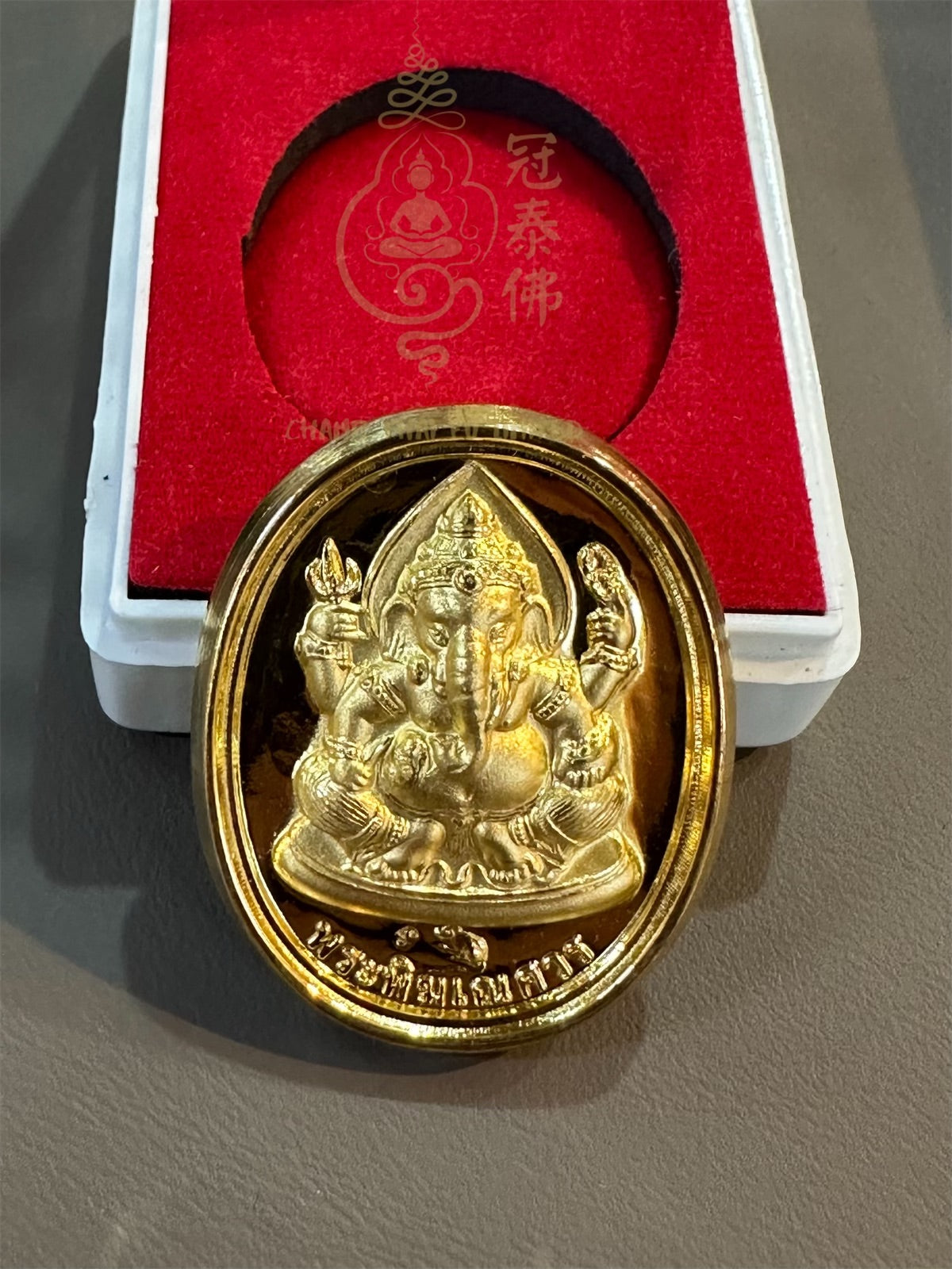 A Chok Dee Meesuk amulet made by Luang Phor Hong, one of the nineteen revered monks of Thailand, in 2547 BE (Buddhist Era). The amulet features a Ganesha (elephant god) on the front and a Phra Phrom (four-faced god) on the back.